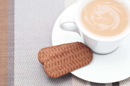 Hot drink and cookies (actually tea and biscuits, but it could be any hot drink). High-key studio shotの写真素材