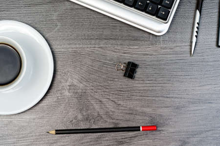 Business items on a wood desk.