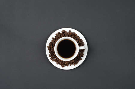 A cup of coffee on a black table.