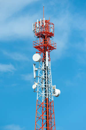 Telecommunication mast TV antennas with blue skyの写真素材