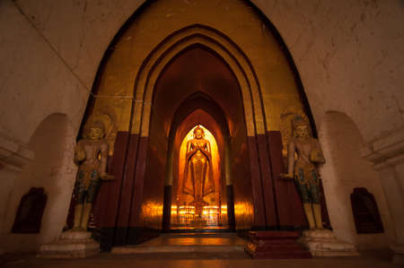 BAGAN, MYANMAR - MAT 4: Standing Buddha Kassapa at south facing part of the Ananda temple adorned by believers by sticking goledn leaves on statue on May 4, 2013 in Bagan, Myanmar.のeditorial素材