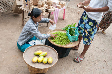 Mandalay, Myanmar - 5 MAY 2015 . Buyer select their goods in the market.のeditorial素材