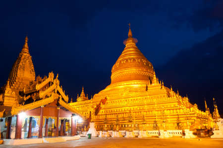 Twilight Shwezigon Pagoda is one of the biggest religious places in Bagan, Myanmar. Covered with...