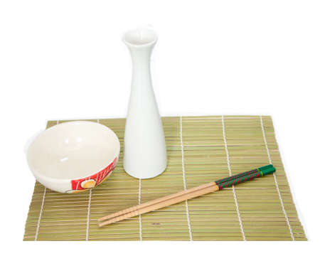 Chopsticks and bowl on bamboo mat ,Isolated white backgroundの写真素材