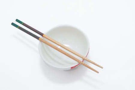bowl with chopsticks on a white backgroundの写真素材