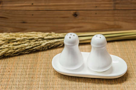 salt and pepper bottles on wooden backgroundの写真素材