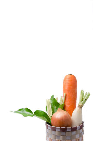 Fresh vegetables Raw Carrot,onion,radish in basket isolated on white backgroundの写真素材