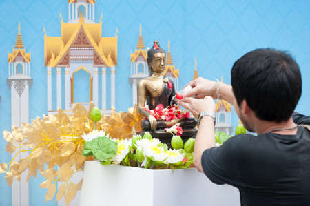 water pouring to Buddha statue in Songkran festival tradition of Bangkok,Thailand 2017