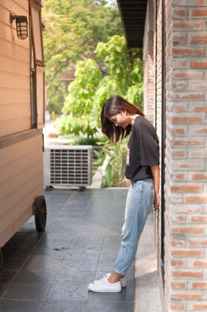 Summer, fashion and people concept - young woman posing outdoor over brick wall,street fashion