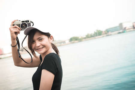Hipster woman taking photos with retro film camera ,Girl Adventure Hangout Traveling Holiday...