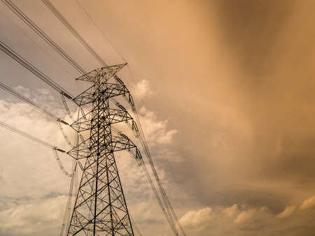 Silhouette of high voltage power plant and transformation station at sunsetの写真素材