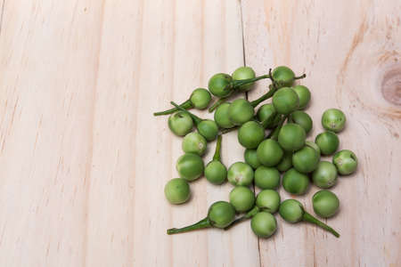 Turkey berry (Solanum torvum Sw.) on a wooden floorの写真素材
