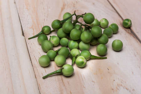 Turkey berry (Solanum torvum Sw.) on a wooden floorの写真素材