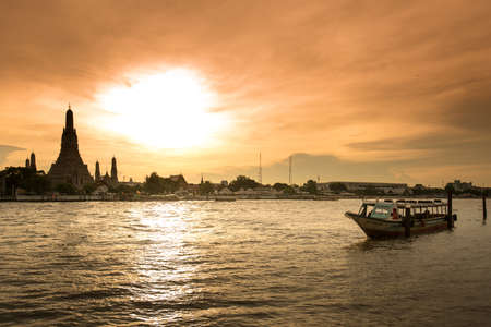 Wat Arun, along the Chao Phraya river  side with a colorful sky at  sunset in Bangkok,Thailandの写真素材