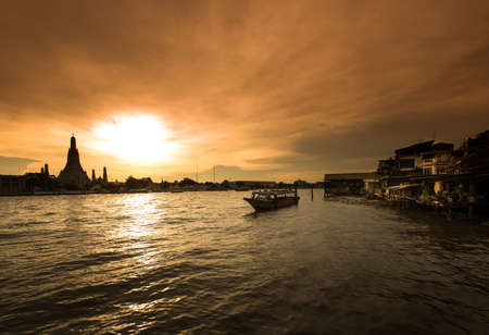 Wat Arun, along the Chao Phraya river  side with a colorful sky at  sunset in Bangkok,Thailandのeditorial素材