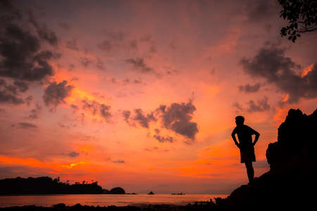 Silhouette of a man on the sunset in nature in summer with open hands. freedom concept