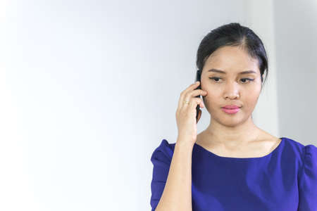 Close up portrait of a happy excited woman talking on mobile phone,Asian Business Woman smiling, Woman stand and showing Smartphone, isolated on white background, Woman working concept.の写真素材