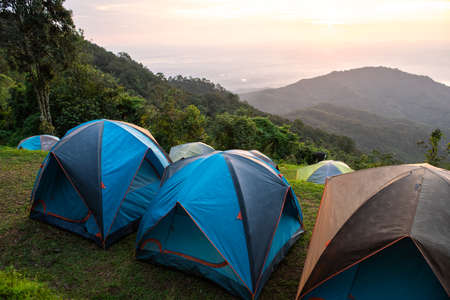 Adventures Camping tourism and tent ,view forest landscape , outdoor in morning and sunset sky at...
