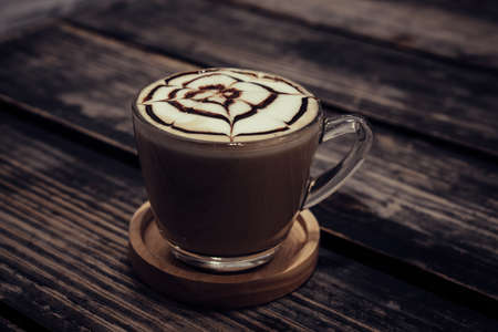 Hot art Latte Coffee in a cup on wooden table in coffee shop