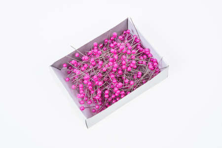 Push pins on box with white background