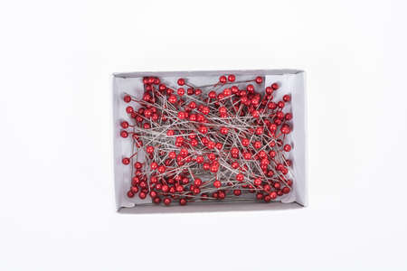 Push pins on box with white background