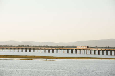Landscape View of  Train crossing Pasak Chonlasit Dam. Reservoir for agriculture at Lopburi,Thailandの写真素材