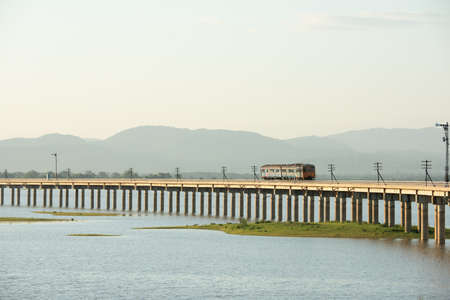 Landscape View of  Train crossing Pasak Chonlasit Dam. Reservoir for agriculture at Lopburi,Thailand