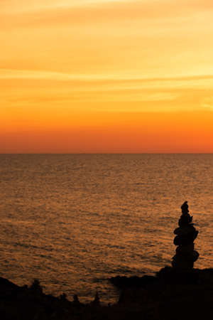 Zen concept. The object of the stones on the rock at sunset. Zen stones.の写真素材
