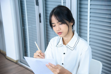 female student sitting taking notes music teacher.の写真素材