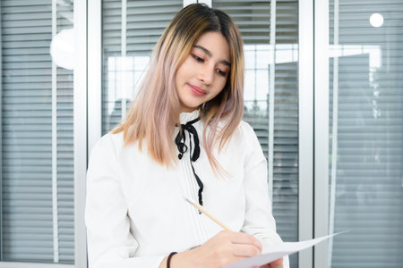 female student sitting taking notes music teacher.の写真素材