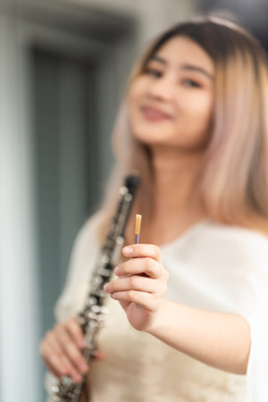 Portrait of Young Female Musician Playing Clarinet. Rehearsal before performing on stage.の写真素材