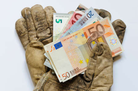 Work gloves with EURO banknotesの写真素材