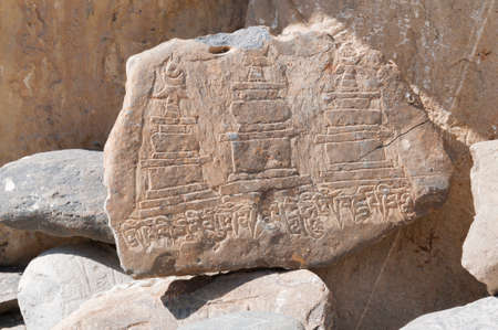 Mani stone, prayer stones with Buddhist symbols in the Annapurna area, Nepal.の写真素材