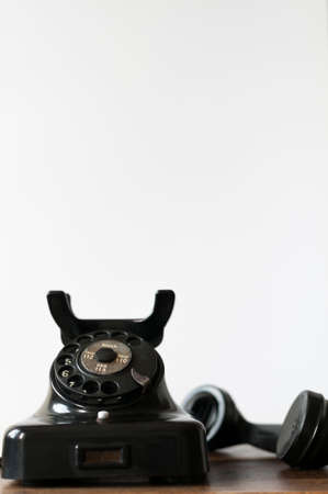 Old phone on a desk and white background for copy space.の写真素材