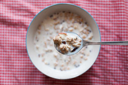Breakfast background, a bowl Muesli with milk.の写真素材