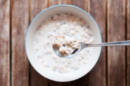 Breakfast background, a bowl Muesli with milk.の写真素材