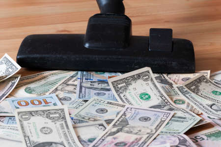 Vacuum cleaner sucks on U.S. dollars.の写真素材