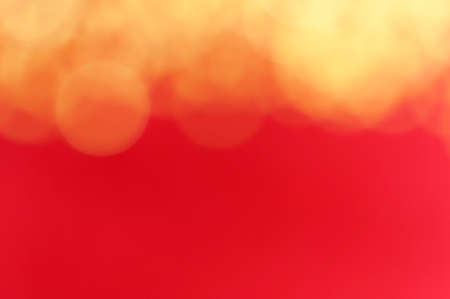 Abstract red blurred retro background with light spots.の写真素材