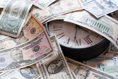 Abstract background of U.S. dollar and a clock.