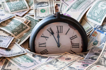 Abstract background of U.S. dollar and a clock.