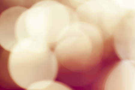 Abstract red blurred retro background with light spots.の写真素材