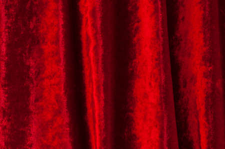 Background of dark red velvet with folds.の写真素材