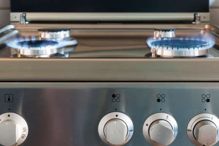 Gas flame of a gas stove in stainless steel.