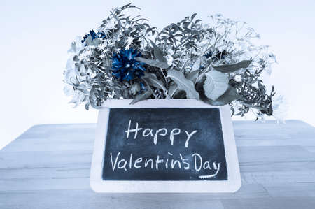 Flower bouquet and blackboard with Valentine greetings, Happy Valentin`s Day.の写真素材