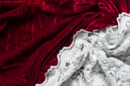 Red velvet and white lace as abstract background.の写真素材