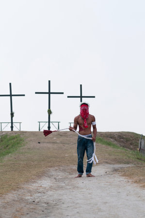 San Fernando , Luzon, Philippines, March 25, 2016: Easter procession in the city of San Fernando, Luzon Island, Philippines. Flagellants who mortify themselves on Good Friday on a field.のeditorial素材