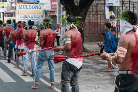 San Fernando , Luzon, Philippines, March 25, 2016 Easter procession in the city of San Fernando, Luzon Island, Philippines. Flagellants who mortify themselves on Good Friday on the road.のeditorial素材