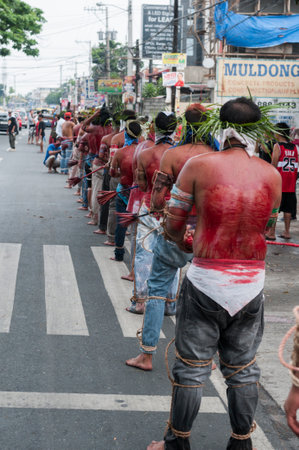 San Fernando , Luzon, Philippines, March 25, 2016 Easter procession in the city of San Fernando, Luzon Island, Philippines. Flagellants who mortify themselves on Good Friday on the road.のeditorial素材