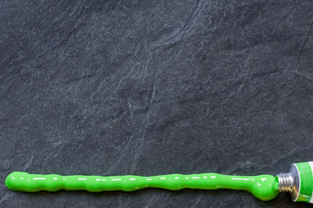 Background, black slate stone with texture and green line.の写真素材