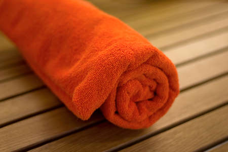 towel braided ore curtailed in a tubule on the wood chairの写真素材